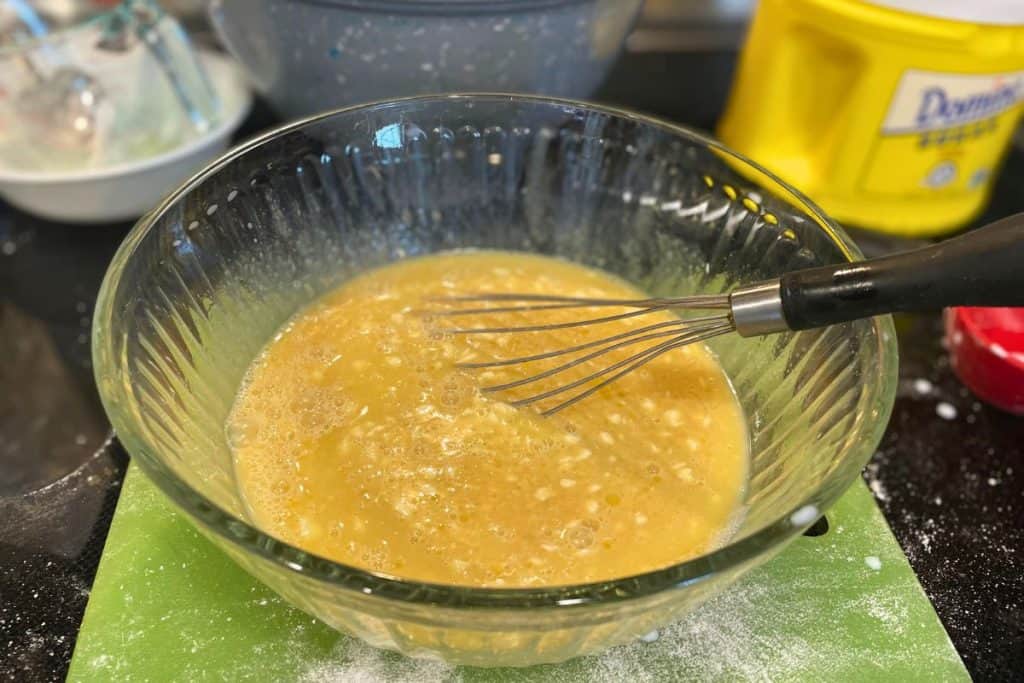 Melted butter added to the wet ingredients for apple muffins