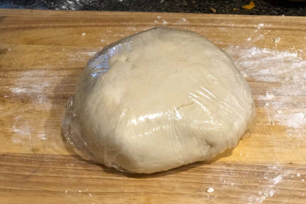 Pop tart pastry dough wrapped in plastic wrap and ready to go rest in the fridge for an hour