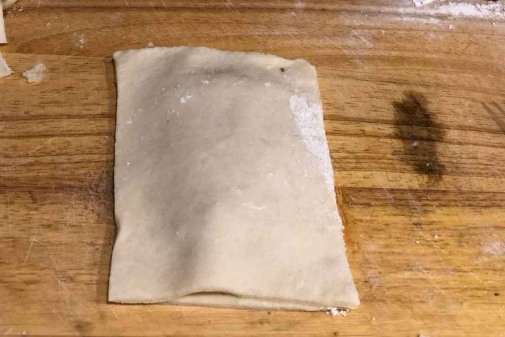 a second piece of crust dough is on top of the pop tart filling