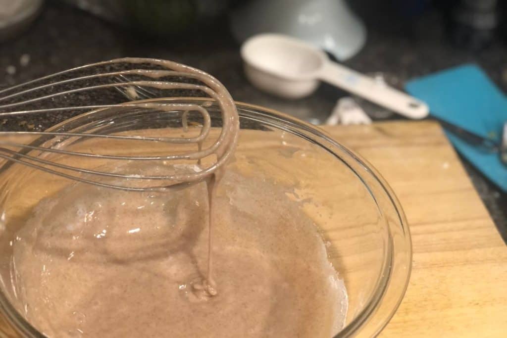 A flat whisk stirring up the brown sugar cinnamon icing for the homemade pop tarts