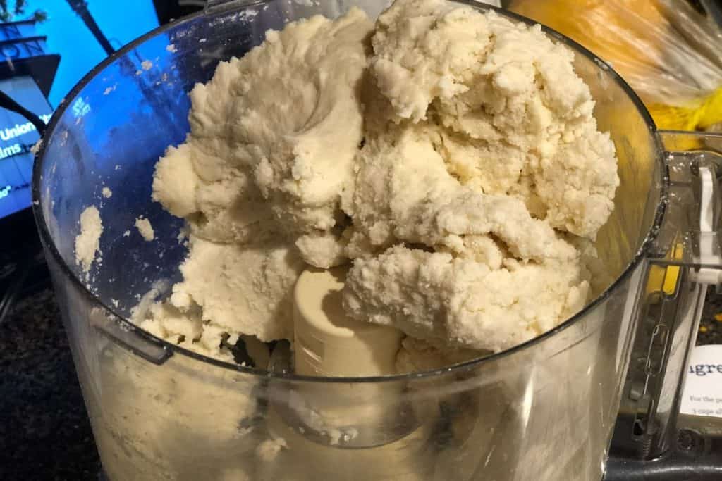 The pie crust dough made in the food processor that has come all the way together because it's balled up into one side of the processor.
