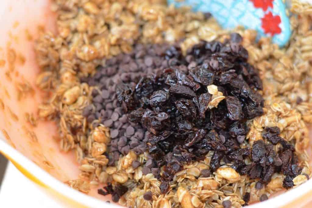 chocolate chips and dried cherries added to the gooey granola mixture as the last add ins of the recipe