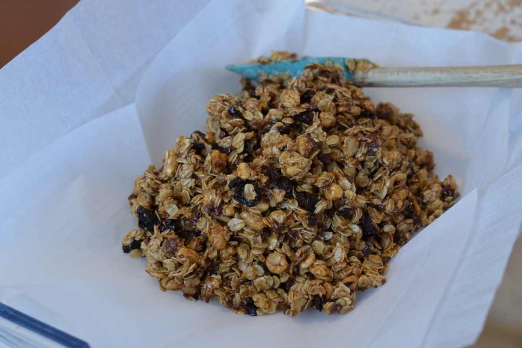 the granola mixture poured into a parchment lined glass baking dish